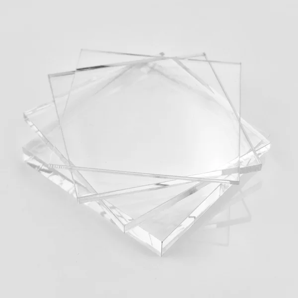 Clear acrylic sheets stacked on top of each other, creating a transparent and orderly arrangement.