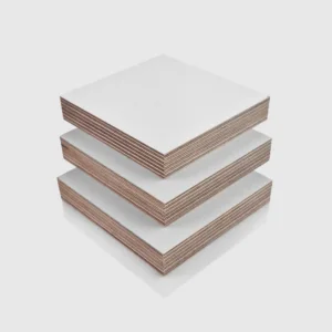 18mm White PP Faced Plywood (WISA Multiwall – Textured) 18mm White PP Faced Plywood (WISA Multiwall) sheets stacked on top of each other, in an orderly arrangement.