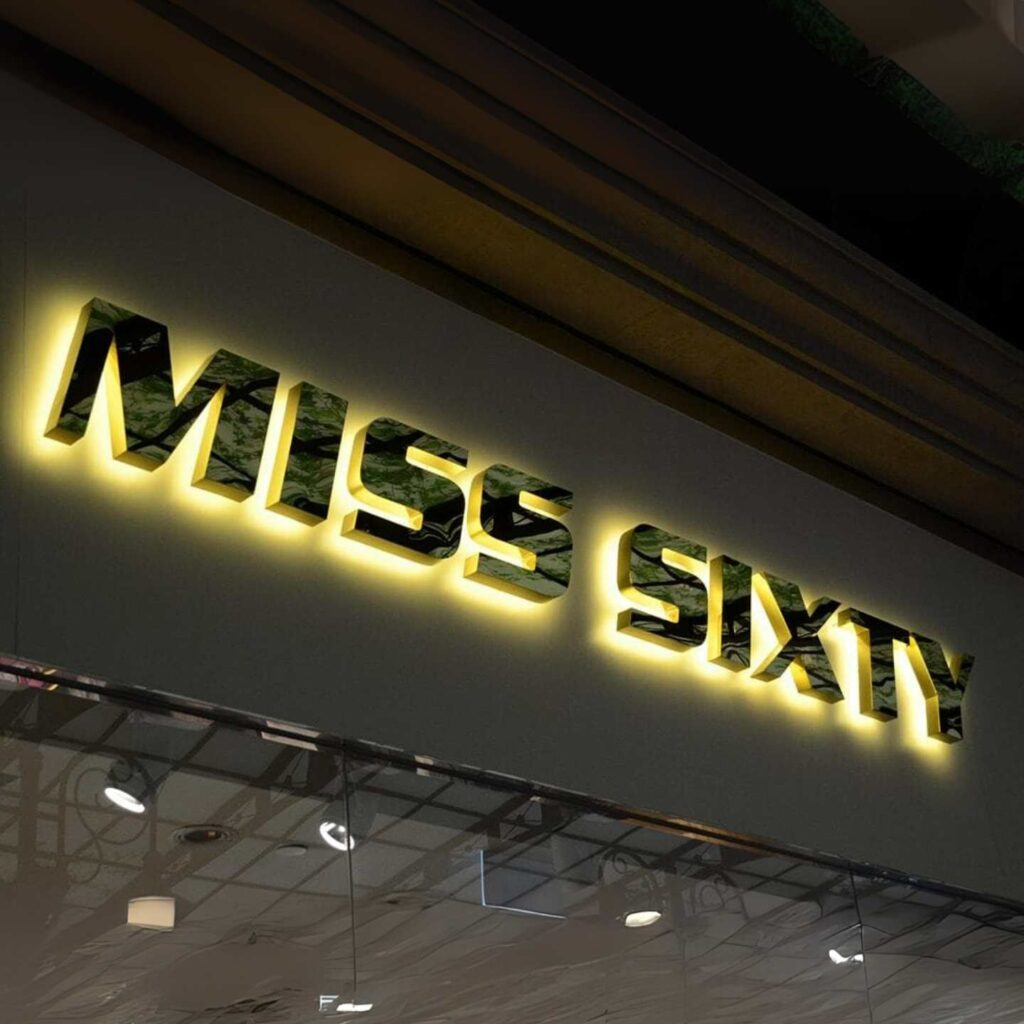 A Miss Sixty sign made from gold mirror with LED backlights.
