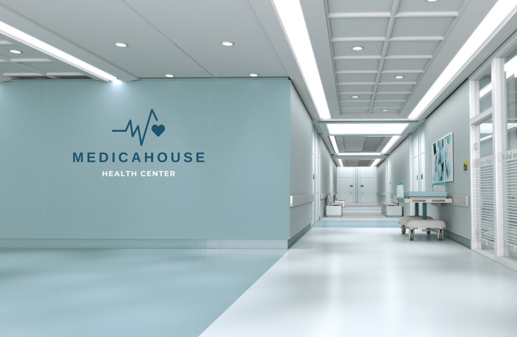 Modern hospital corridor featuring hygienic wipe-clean PVC wall cladding with digitally printed medical branding, designed for clean, sterile healthcare environments.